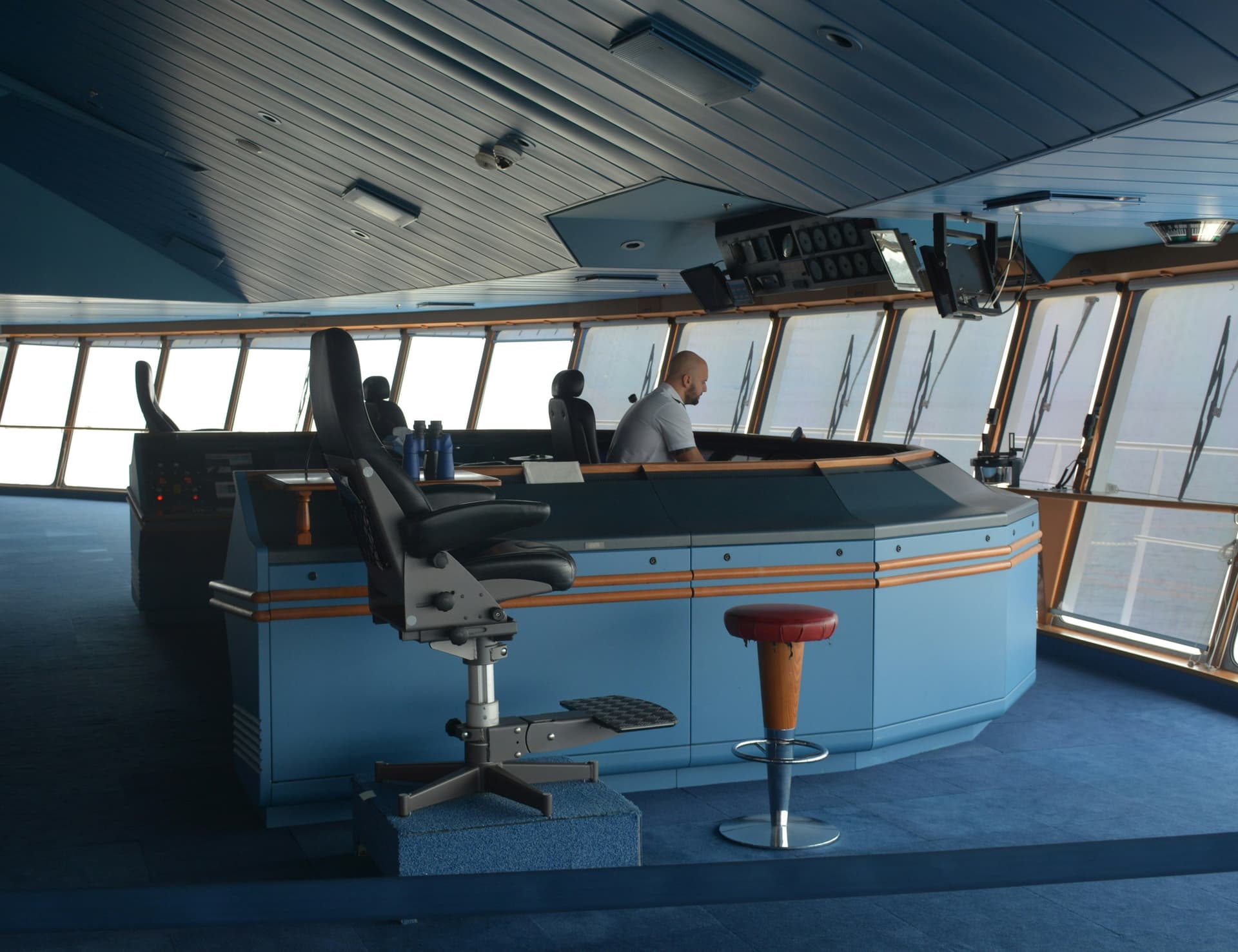 An officer at the console on a ship's bridge