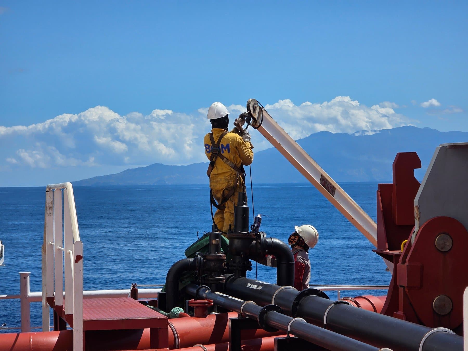 Crewman working at a deck crane
