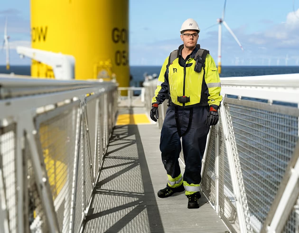 A technician on the gangway from a Norwind vessel to a wind turbine