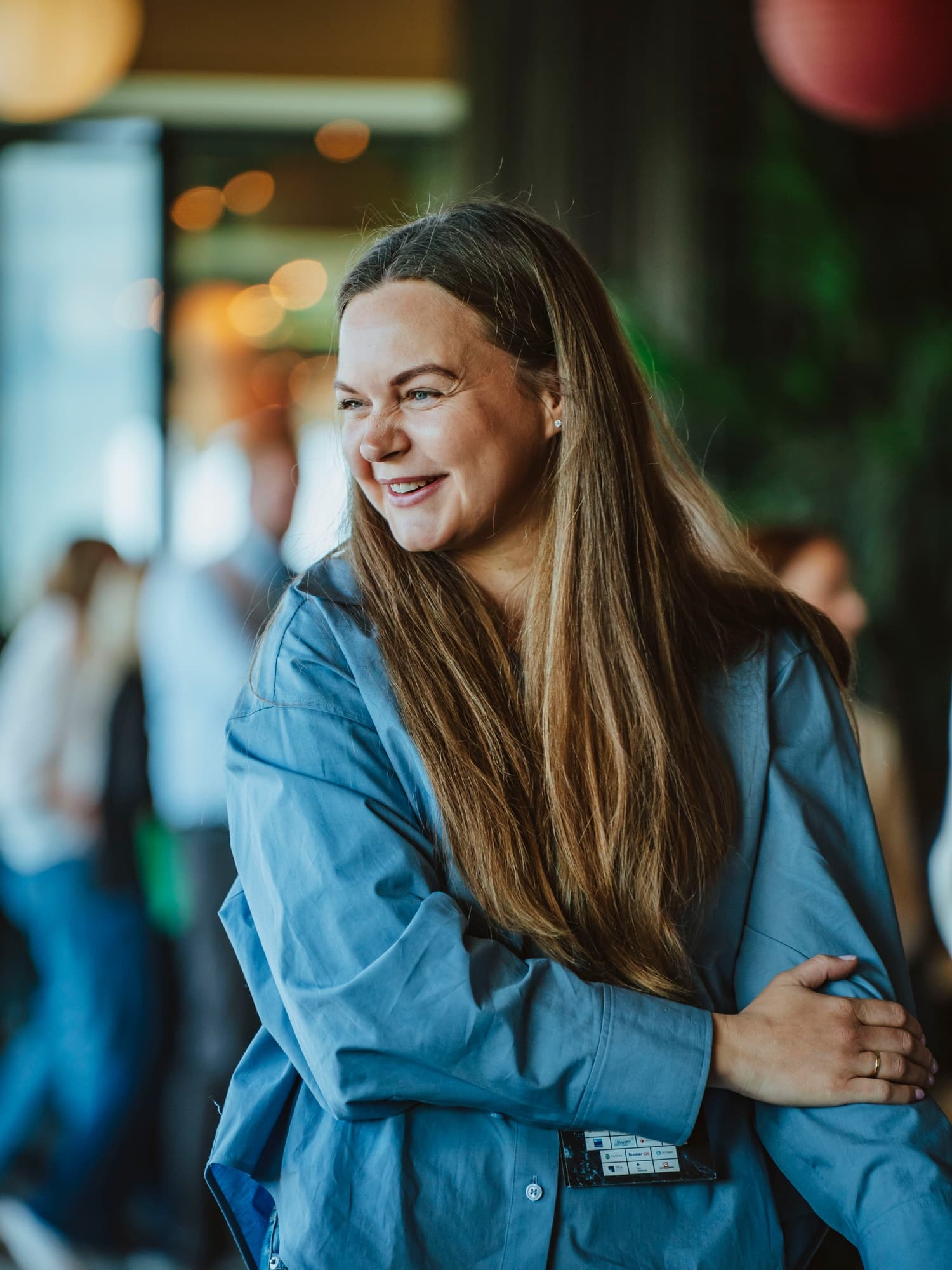 Andrea Dyb smiling, looking to the side, in a blue shirt at The Next Wave 2026