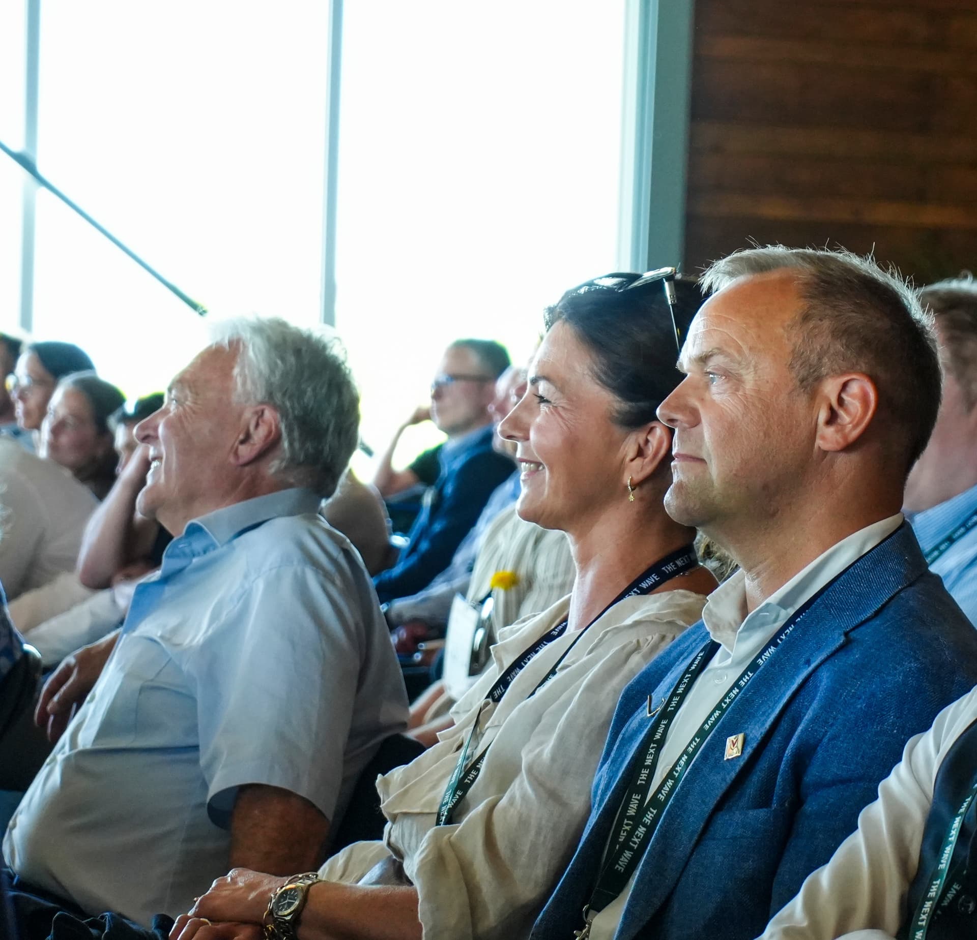 Sindre Johan Dyb in a blue jacket, seated in the audience at The Next Wave, listening